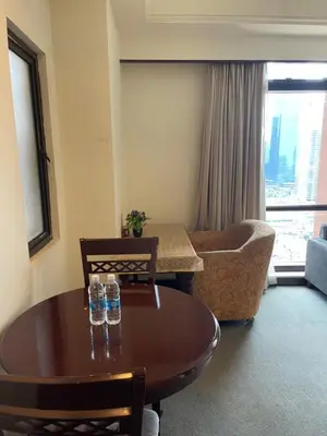 a living room with a table and a couch at KL Elegant Apartment at Times Square in Kuala Lumpur