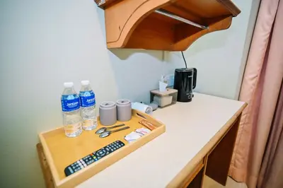 a tray with bottles of water and other items on a counter at Swing & Pillows - Petaling Street Kuala Lumpur in Kuala Lumpur