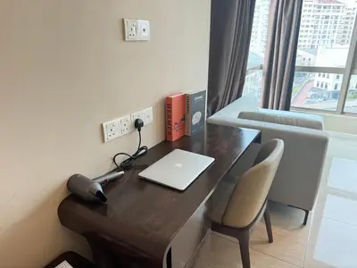 an office with a desk with a laptop and a chair at Dorsett Residence Sri Hartamas by Chengal with Bathtub, Rooftop Pool, KL City Centre, Round the Clock Security, Netflix, Youtube, Free Parking in Kuala Lumpur