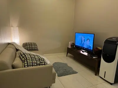a living room with a couch and a flat screen tv at Dorsett Residence Sri Hartamas by Chengal with Bathtub, Rooftop Pool, KL City Centre, Round the Clock Security, Netflix, Youtube, Free Parking in Kuala Lumpur