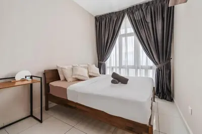 a bedroom with a bed and a large window at Cozy Apartment with KLCC View & 1 Min to LRT Station in Kuala Lumpur