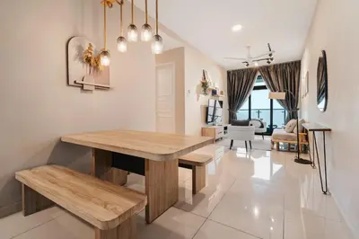 a dining room with a wooden table and a living room at Cozy Apartment with KLCC View & 1 Min to LRT Station in Kuala Lumpur