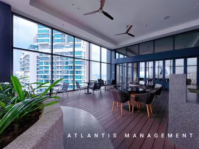 an office building with a table and chairs and windows at KL Eco City Luxury 2 Bedrooms Apartment, Walking Distance to Mid Valley & The Garden & LRT in Kuala Lumpur