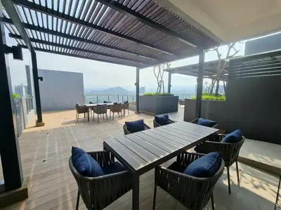 a patio with a wooden table and chairs and the ocean at Muji Tiny Studio Near KLCC in Kuala Lumpur