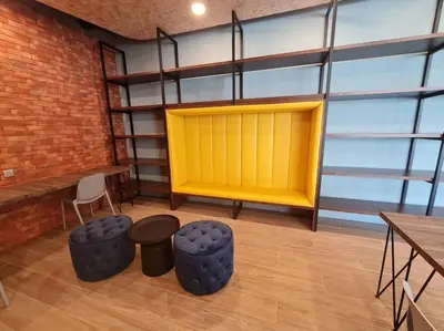 a room with a yellow door and some tables and chairs at Muji Tiny Studio Near KLCC in Kuala Lumpur