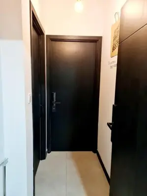 a hallway with a black door in a room at Muji Tiny Studio Near KLCC in Kuala Lumpur