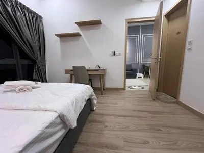 a bedroom with a bed and a desk and a table at THE COLONY INFINITUM Sweet Home SR in Kuala Lumpur