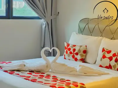two swans making a heart on a bed at Lila Suites Agile, Bukit Bintang ,KLCC in Kuala Lumpur