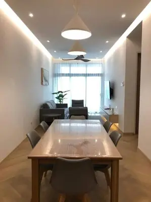 a living room with a table and some chairs at The suits klcc in Kuala Lumpur
