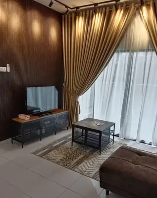a living room with a flat screen tv and a couch at The suits klcc in Kuala Lumpur