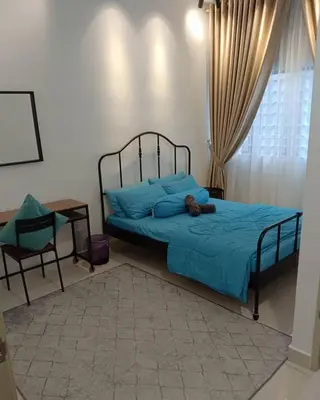 a bedroom with a bed with a teddy bear on it at The suits klcc in Kuala Lumpur