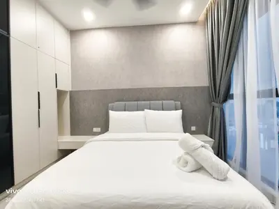 a bedroom with a bed with white sheets and a window at KL Premium Dual Key Studio with KLCC view on the 56th floor in Kuala Lumpur