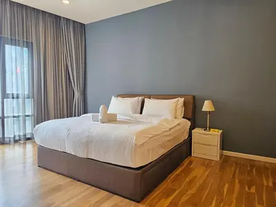 a bedroom with a large bed with white sheets and a lamp at Resort Style Haven 3BR6pax St Mary KLCC Twin Towers View in Kuala Lumpur