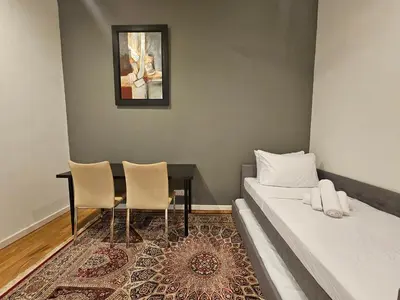 a room with a bed and a table and chairs at Resort Style Haven 3BR6pax St Mary KLCC Twin Towers View in Kuala Lumpur