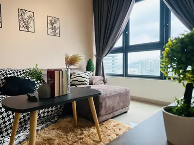 a living room with a couch and a table with books at MVD41#Family Suite 8pax 3 Rooms M Vertica Velocity Mall Cheras IKEA Mytown Short Walk to MRT & LRT Maluri in Kuala Lumpur