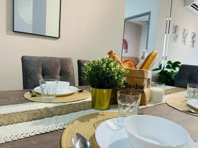 a dining room table with plates and dishes on it at MVD41#Family Suite 8pax 3 Rooms M Vertica Velocity Mall Cheras IKEA Mytown Short Walk to MRT & LRT Maluri in Kuala Lumpur