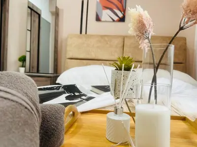 a coffee table with two vases and flowers on it at MVD41#Family Suite 8pax 3 Rooms M Vertica Velocity Mall Cheras IKEA Mytown Short Walk to MRT & LRT Maluri in Kuala Lumpur