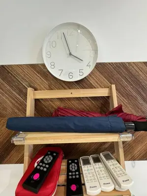 a clock and three remote controls on a shelf at PavKlccTrxVelo ,MrtLrt ,13PAX ,4R2B ,Free KLCCPavTRXVelocity X MrtLrt X 13PAX X 4R2B X Free 4CPark in Kuala Lumpur