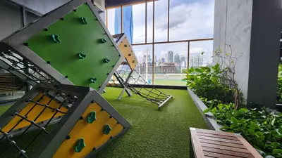 a gym with a climbing wall in a building at Opus Residences Kuala Lumpur by Infini Suites in Kuala Lumpur