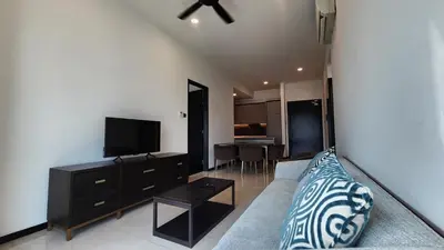a living room with a couch and a flat screen tv at Opus Residences Kuala Lumpur by Infini Suites in Kuala Lumpur
