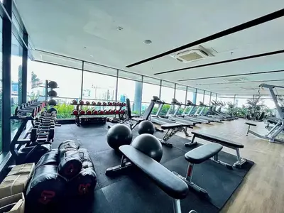 a gym with a lot of equipment in a building at Maxhome Cozy at The Luxe in Kuala Lumpur