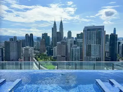 a swimming pool with a view of a city skyline at Maxhome Cozy at The Luxe in Kuala Lumpur
