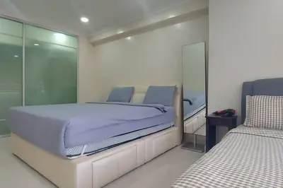 a bedroom with two beds and a mirror at Fahrenheit 88, Bukit Bintang 10 in Kuala Lumpur