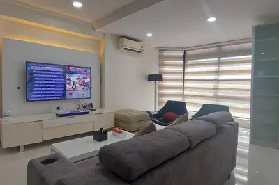 a living room with a couch and a flat screen tv at Fahrenheit 88, Bukit Bintang 10 in Kuala Lumpur