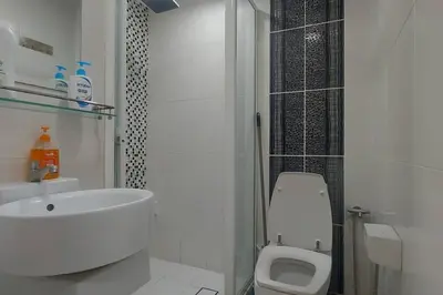 a white bathroom with a sink and a toilet at Fahrenheit 88, Bukit Bintang 10 in Kuala Lumpur