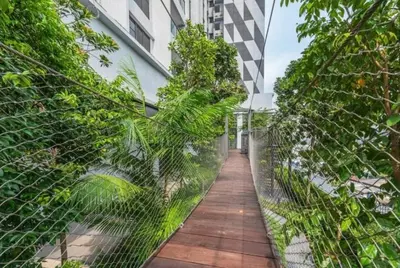 a fence with a walkway in front of a building at TRION KL, KLCC TRX IKEA at Chan Sow Lin, Kuala Lumpur by ONE Guesthouse in Kuala Lumpur