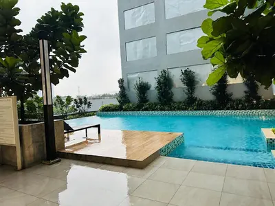 a swimming pool in front of a building at Neu Suites Service Apartment By Moonlight in Kuala Lumpur