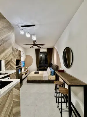 a bedroom with a bed and a kitchen with a bar at Neu Suites Service Apartment By Moonlight in Kuala Lumpur