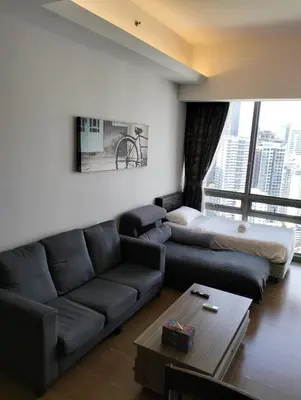 a living room with a couch and a bed at Star Suites At Swiss Garden Residences in Kuala Lumpur