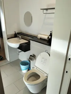 a small bathroom with a toilet and a sink at Star Suites At Swiss Garden Residences in Kuala Lumpur