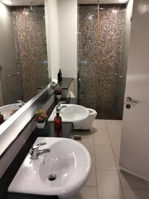 a bathroom with two sinks and a shower at Star Suites At Swiss Garden Residences in Kuala Lumpur