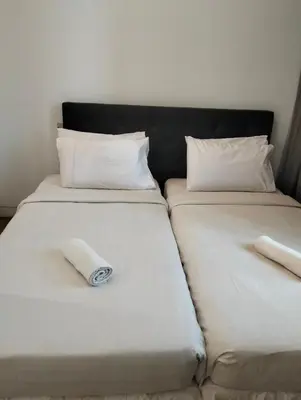 two beds in a room with two pillows at Star Suites At Swiss Garden Residences in Kuala Lumpur