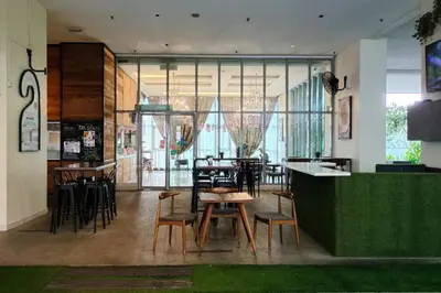 a restaurant with chairs and tables and a bar at Immersed in the warmth and natural ambience in Kuala Lumpur