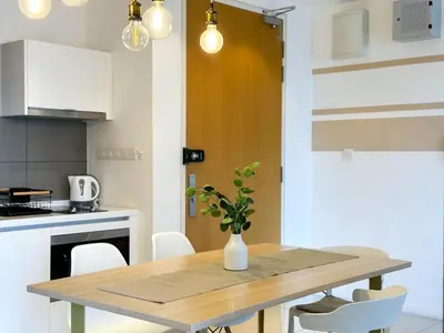 a kitchen and dining room with a wooden table at 5 pax - Bangsar South - 7 mins drive to Mid Valley in Kuala Lumpur
