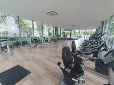 a gym with a row of treadmills and elliptical machines at Super suite at Dorsett residence bukit bintang kl in Kuala Lumpur