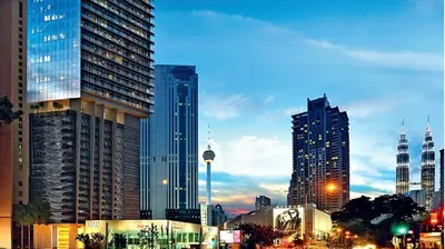 a city skyline with tall skyscrapers in a city at Super suite at Dorsett residence bukit bintang kl in Kuala Lumpur