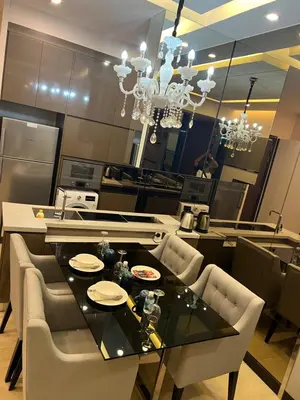 a dining room with a black table and chairs at Super suite at Dorsett residence bukit bintang kl in Kuala Lumpur