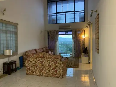 a living room with a couch and a large window at Cityscape KL in Kuala Lumpur