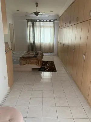 a bedroom with a bed and wooden cabinets at Cityscape KL in Kuala Lumpur