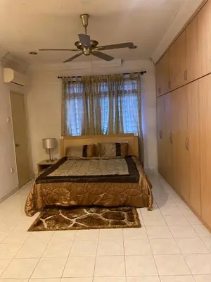 a bedroom with a bed and a ceiling fan at Cityscape KL in Kuala Lumpur