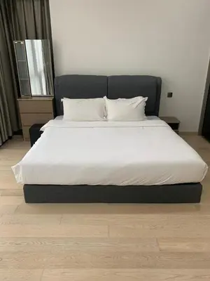 a large bed with white sheets and pillows in a bedroom at Holiday Suites Star Residences in Kuala Lumpur