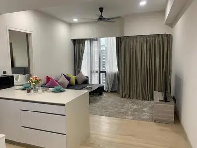 a room with a living room with a couch and a living room with a couch at Holiday Suites Star Residences in Kuala Lumpur