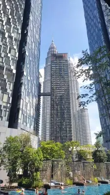 a pool of water in front of tall buildings at Holiday Suites Star Residences in Kuala Lumpur