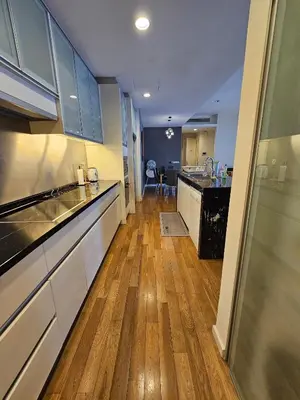 a kitchen with white cabinets and a wooden floor at City Vibe Oasis St Mary Pavilion KLCC 3Bed6pax in Kuala Lumpur