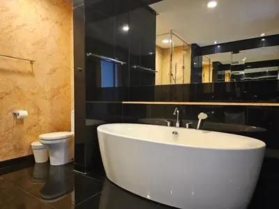 a bathroom with a white tub and a toilet at City Vibe Oasis St Mary Pavilion KLCC 3Bed6pax in Kuala Lumpur