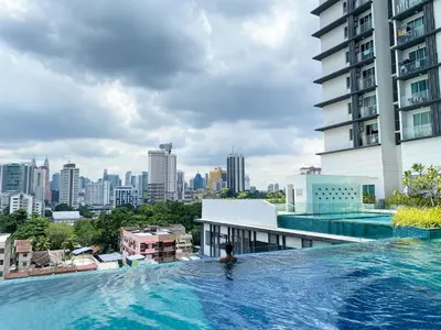 a swimming pool with a city skyline in the background at 2B2B Cozy - 5 min to PWTC - Sentul KL in Kuala Lumpur